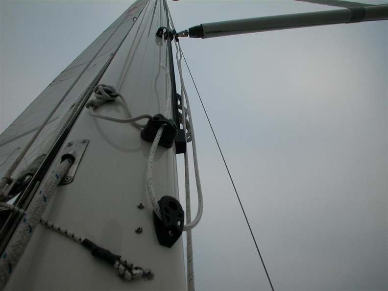The butt end of the pole is attached to a track on the front of the mast where the pole stores