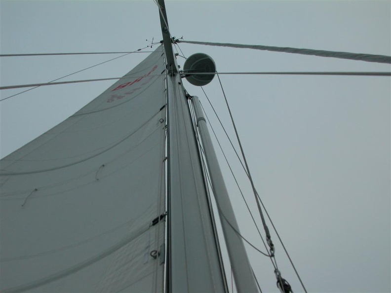 The pole stored on its track up the front of the mast